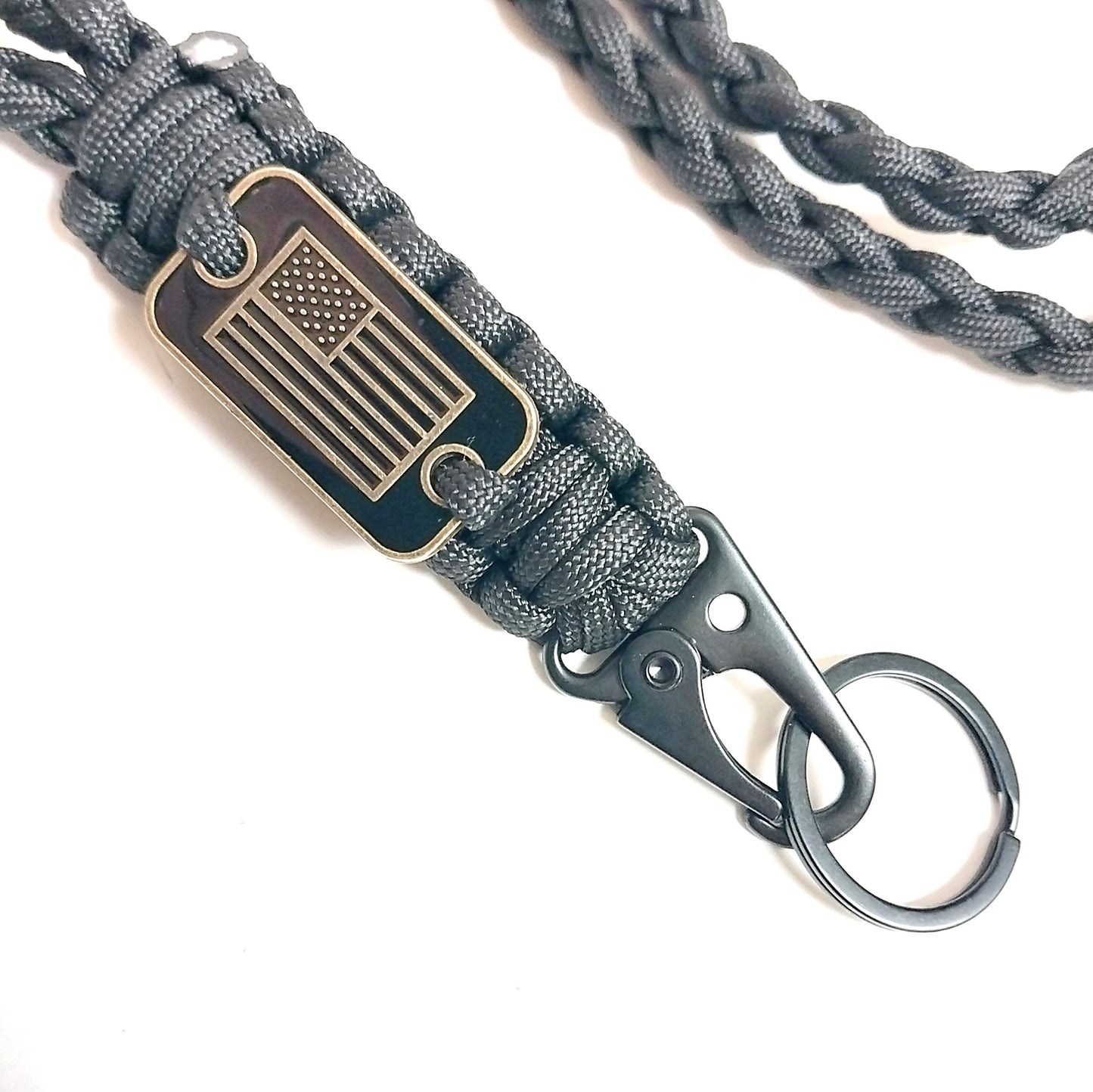 Close-up of USA emblem plaque woven into black paracord lanyard